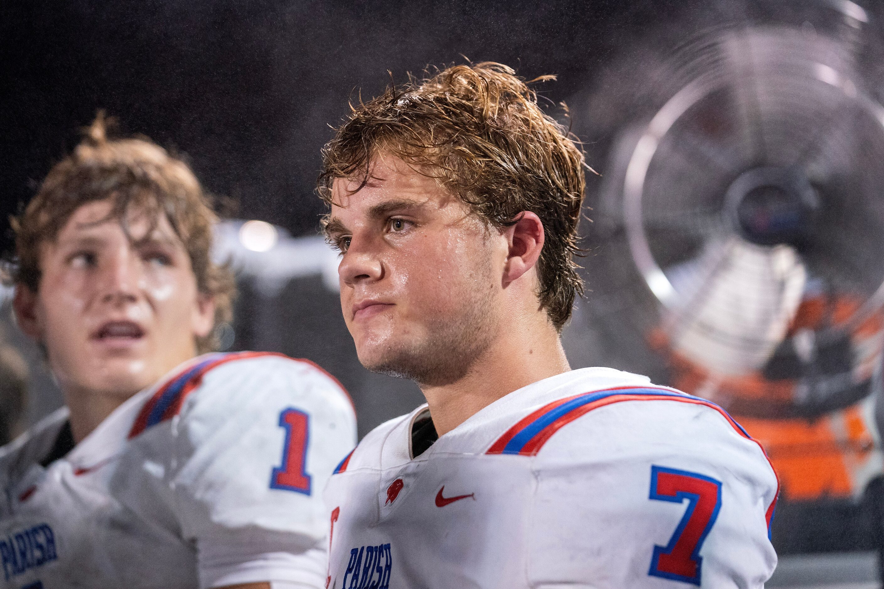 Parish Episcopal senior quarterback Sawyer Anderson (7) sits in front of a fan on the bench...