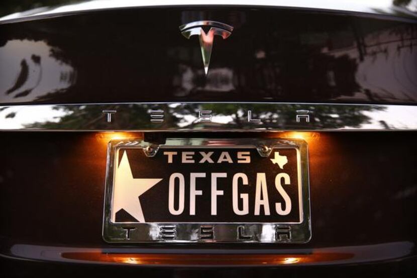 Brad Holt of Dallas has personalized plates touting his all-electric Tesla Model S,...