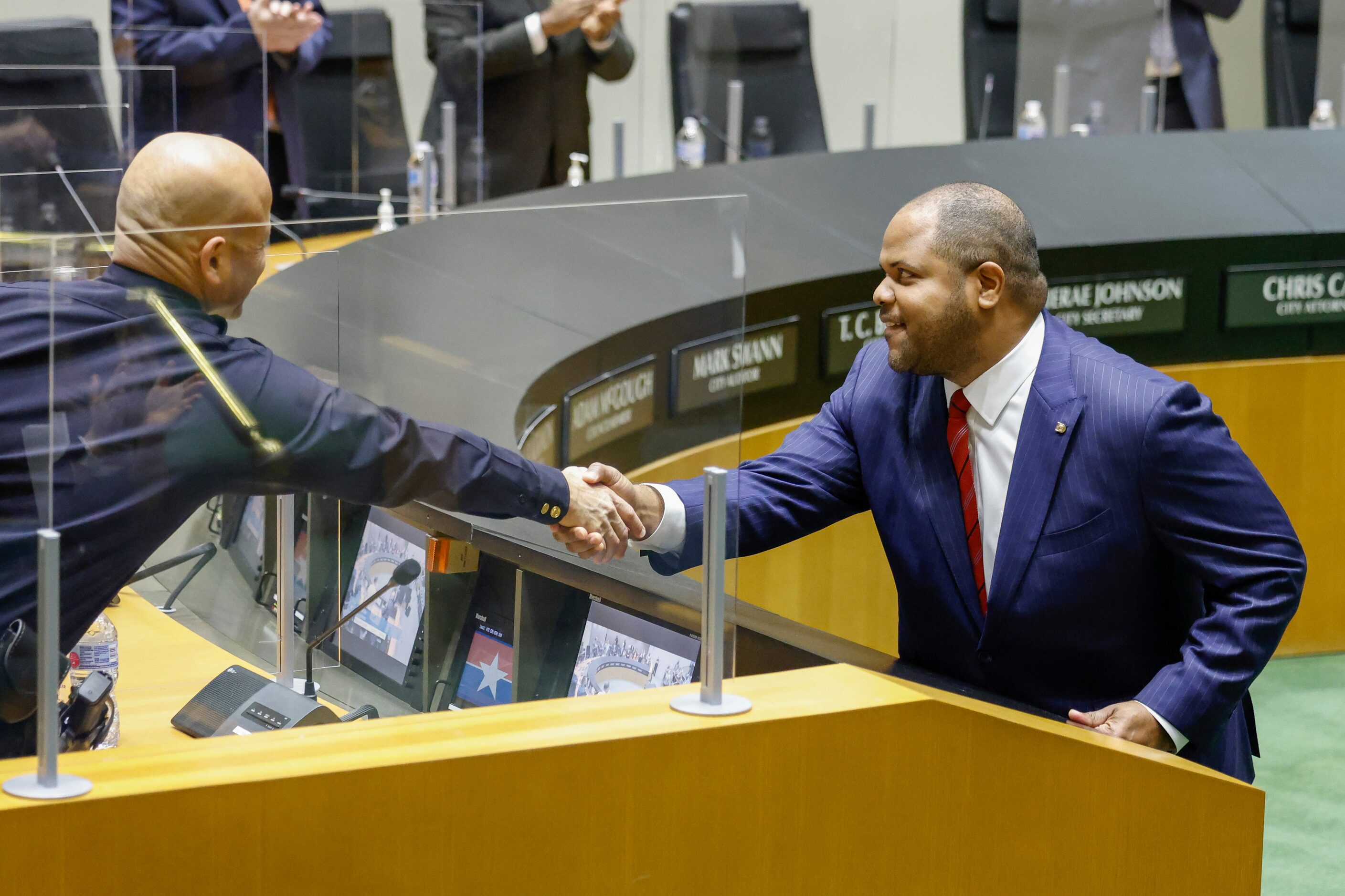 Dallas Mayor Eric Johnson (right) greets Dallas police chief Eddie García before his state...