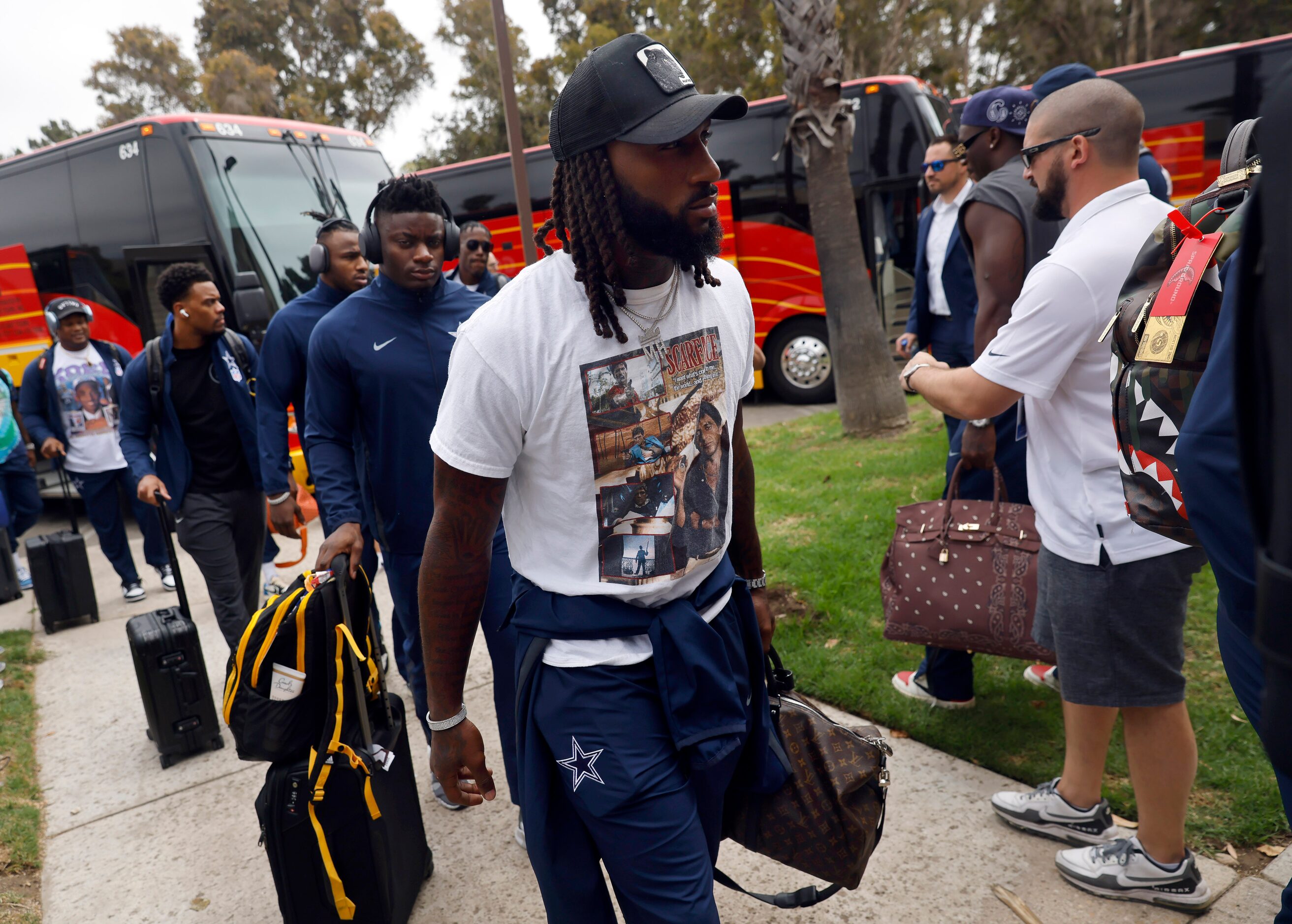 Dallas Cowboys safety Malik Hooker and his teammates arrive on buses at the Residence Inn...