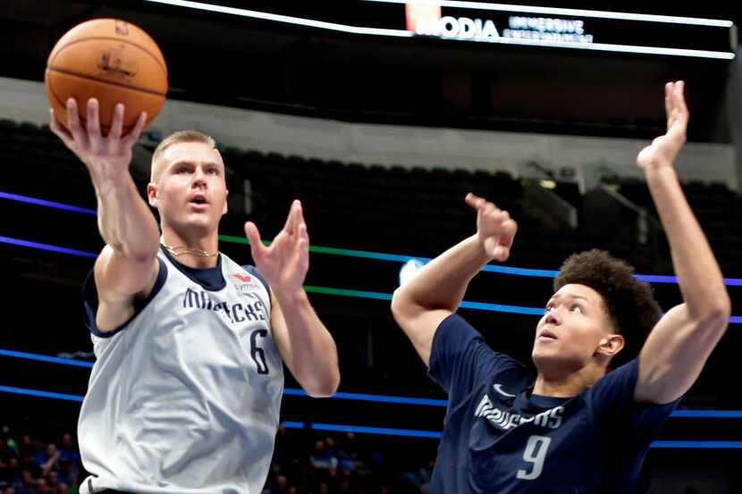 Dallas Mavericks center Kristaps Porzingis (6) drives to the basket past forward Isaiah Roby...