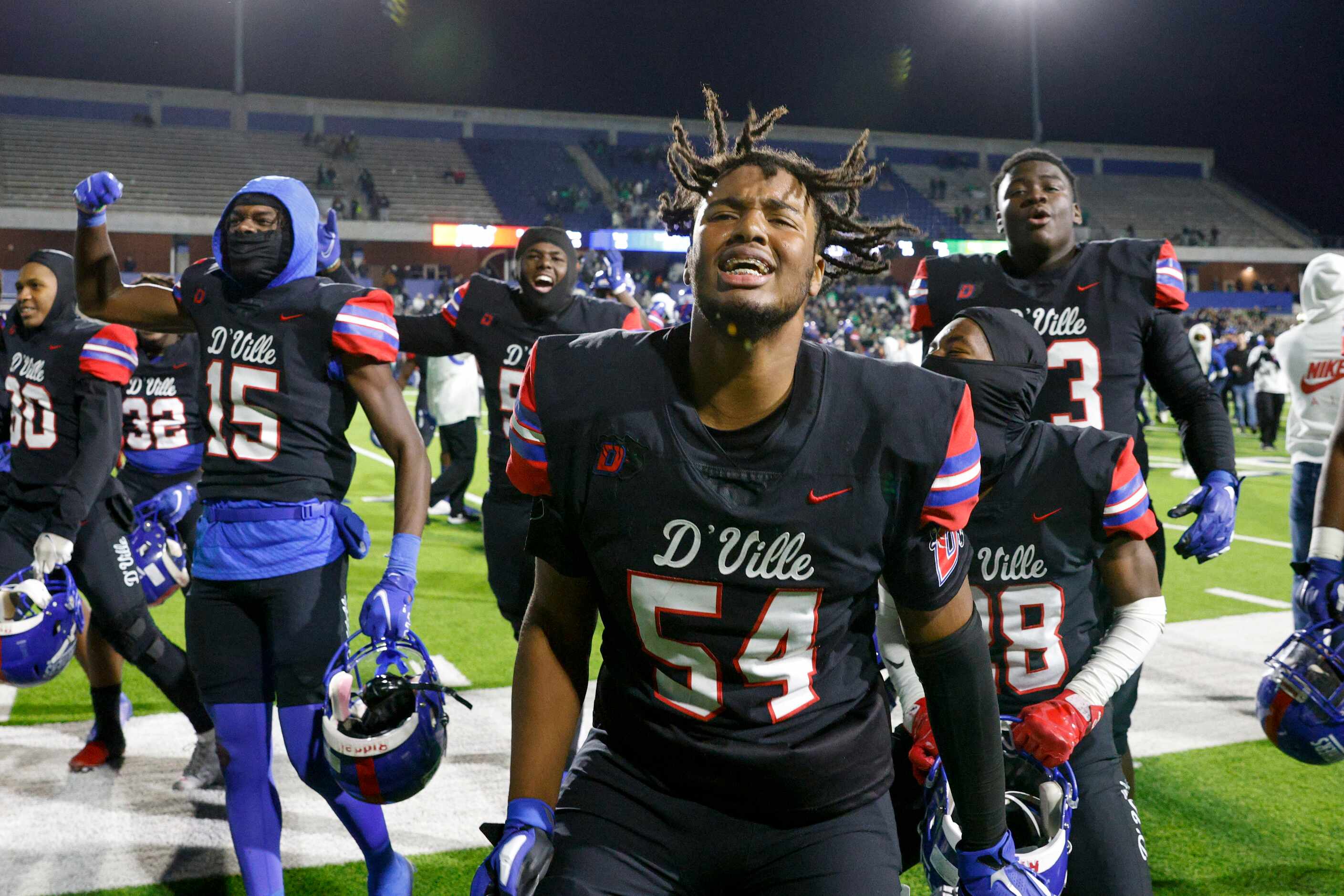Duncanville offensive lineman Jerry Scales (54) celebrates with teammates after defeating...