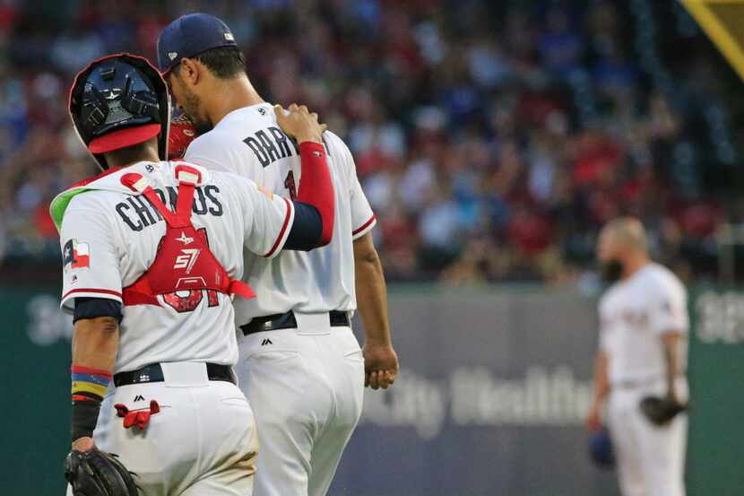 Texas Rangers catcher Robinson Chirinos (61) talks with  pitcher Yu Darvish (11) during the...
