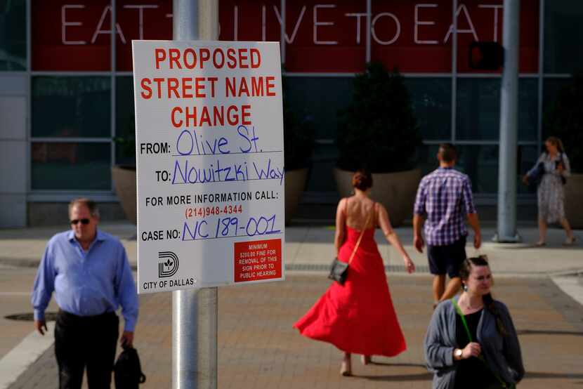 A sign at Olive Street and Victory Park Lane gives notice of a proposed renaming of Olive...