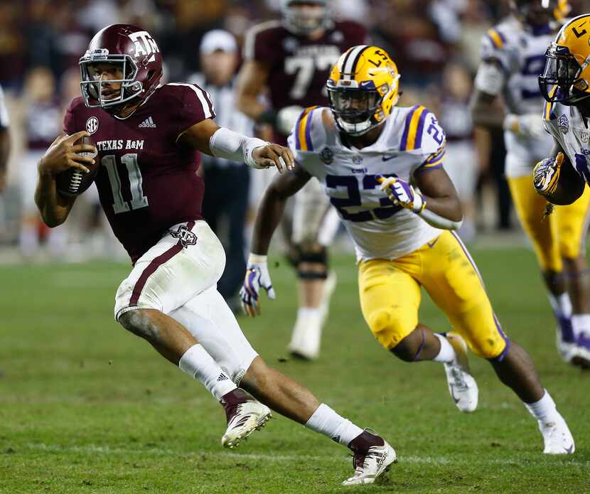 COLLEGE STATION, TEXAS - NOVEMBER 24: Kellen Mond #11 of the Texas A&M Aggies rushes past...