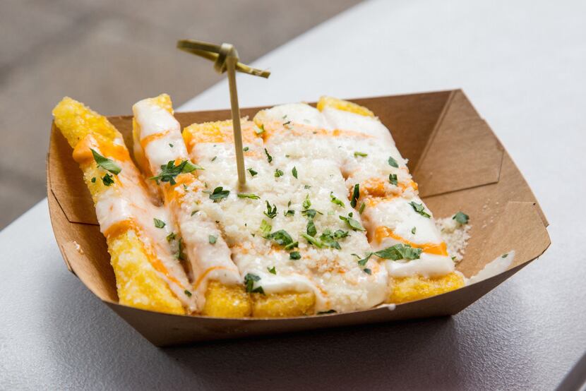 The Lucky Fig's polenta fries come topped with cheese sauce, tomato aioli and parmigiano...