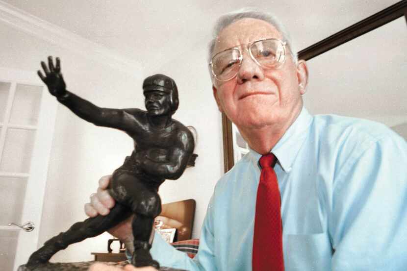 John David Crow poses with his Heisman Trophy at his home in College Station.