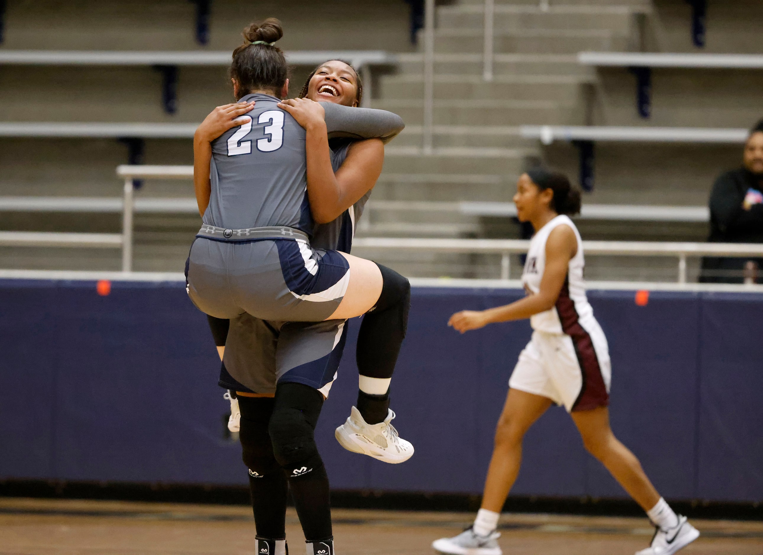 Wylie East’s Kiley Hicks (23) and Akasha Davis (41) celebrate their overtime win (65-60)...