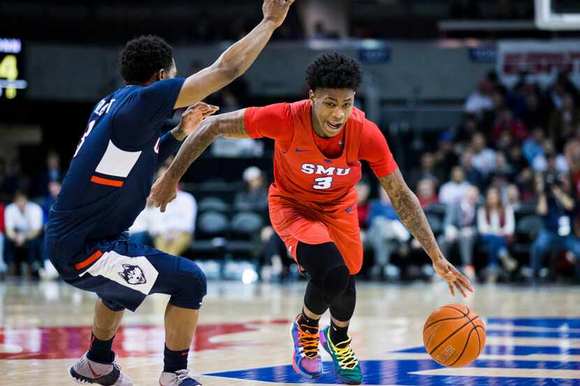 Southern Methodist Mustangs guard Kendric Davis (3) gets around Connecticut Huskies guard...