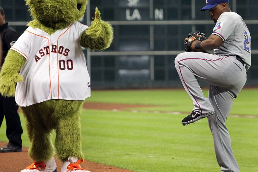 Texas third baseman Adrian Beltre gets some advice from Astros mascot "Orbit" before the...