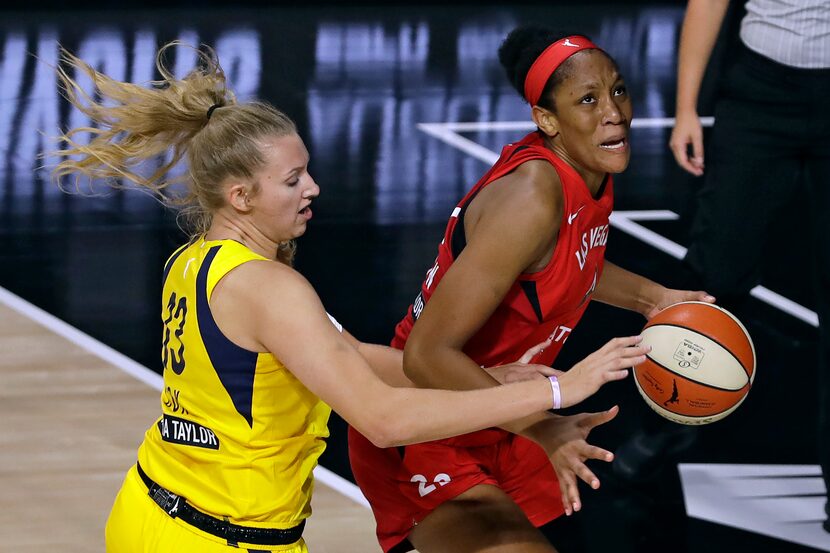 Las Vegas Aces center A'ja Wilson (22) drives around Indiana Fever forward Lauren Cox during...