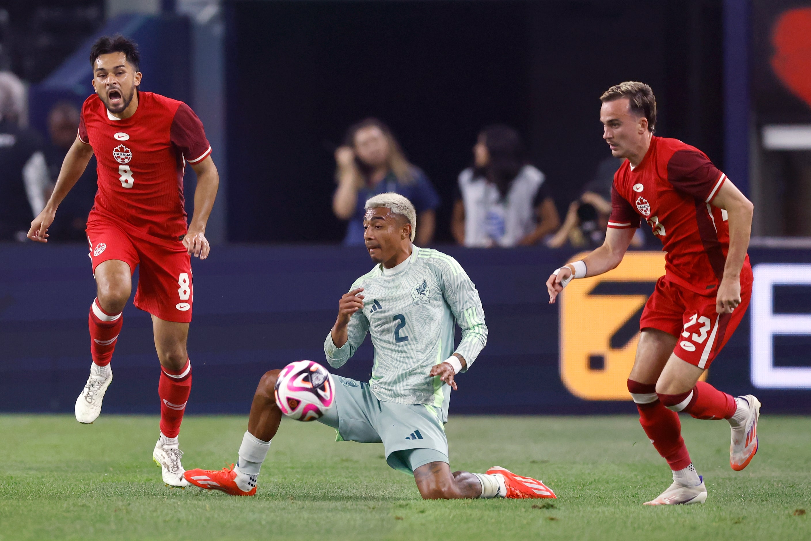 Canada midfielder Mathieu Choiniere (8) reacts after a tackle by Mexico defenseman Julian...