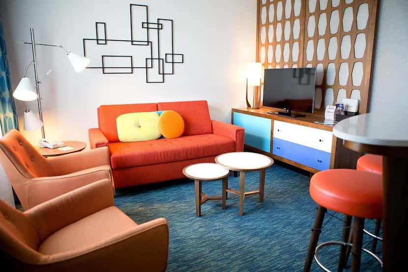 Colorful 1950s-themed  furniture fills the interior of a courtyard family suite poolside...