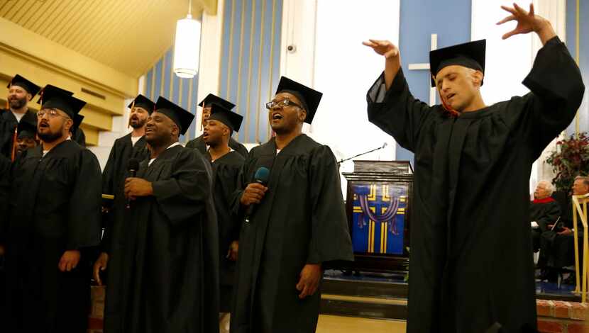  Inmates including Scott Copeland (right) sing gospel music during the commencement of...