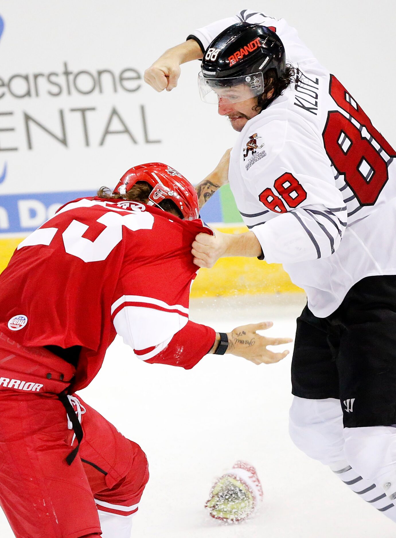 Allen Americans defenseman Cole Fraser (23) and Rapid City Rush forward Garrett Klotz duke...