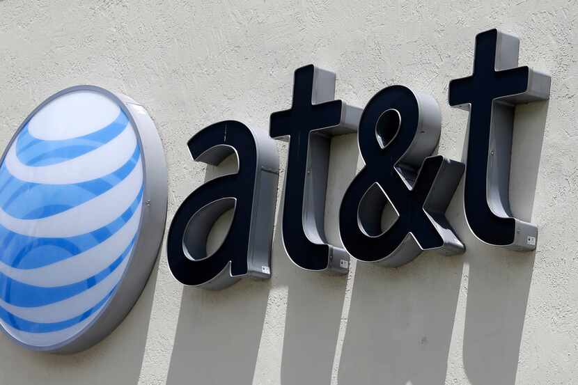 This July 27, 2017, file photo shows an AT&T logo at a store in Hialeah, Fla. Current and...