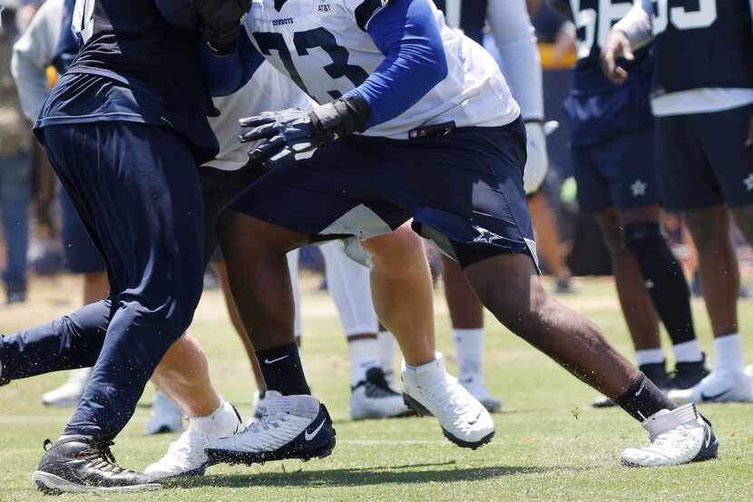 Dallas Cowboys rookie offensive tackle Tyler Smith (73) blocks defenders during the first...