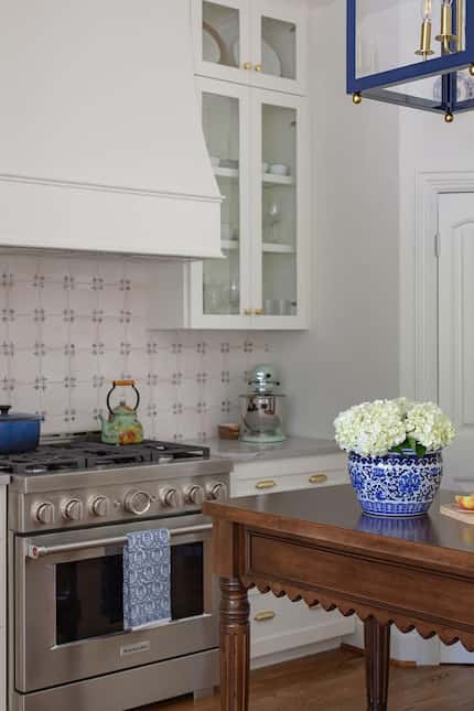A hand-painted TK tile completes this traditional kitchen's aesthetic.