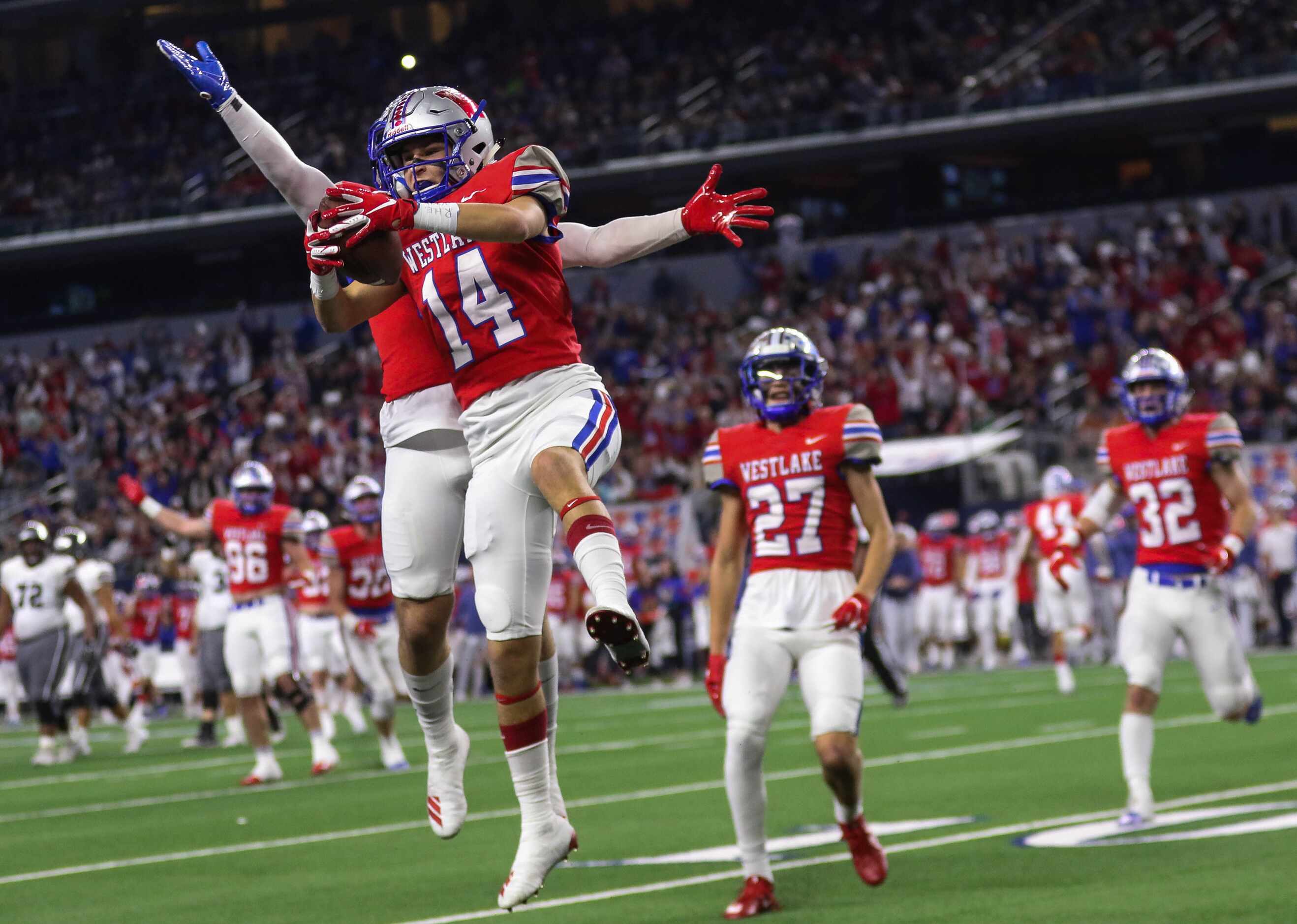 Austin Westlake's Michael Taaffe (14) celebrates his interception in the first quarter of a...