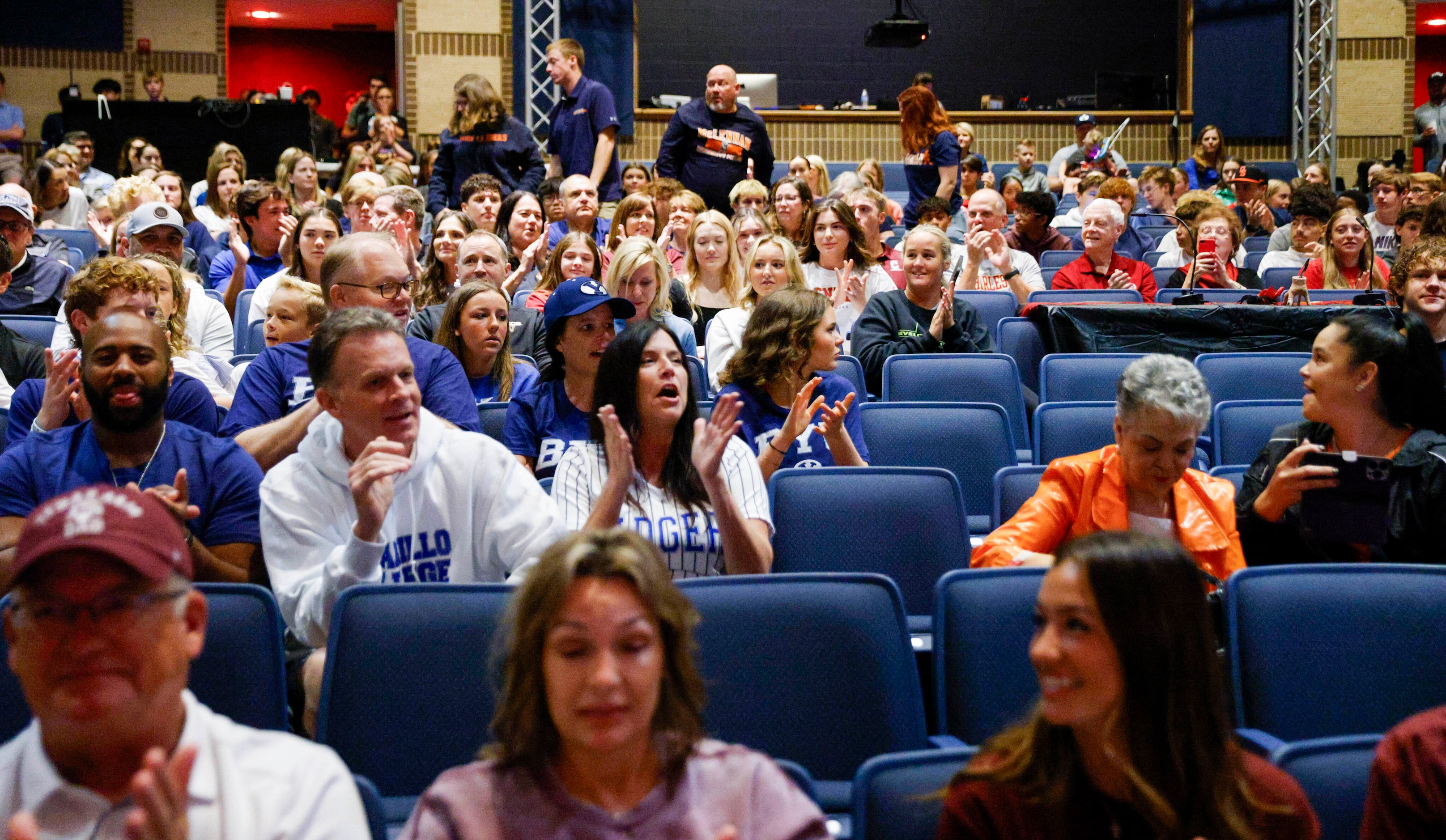 Keller students and family members clap during a national letter of intent signing ceremony...