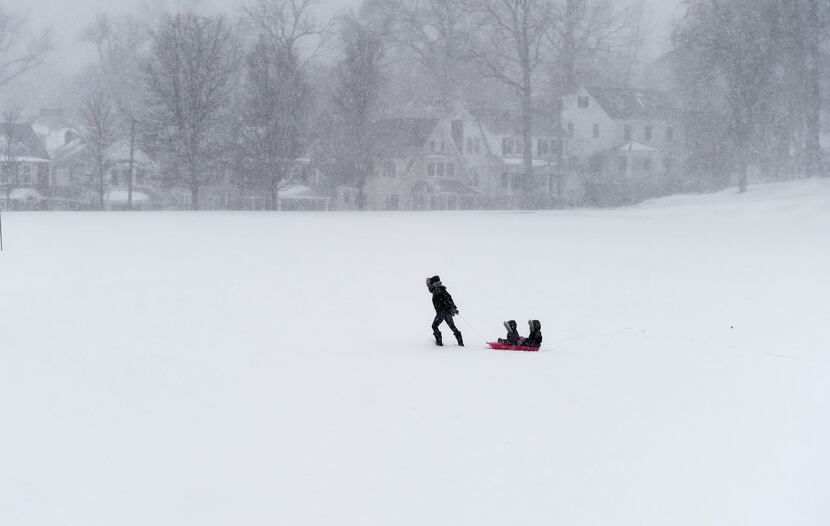 A woman pulls her kids on a sled through Havemeyer Fields in Greenwich, Connecticut January...