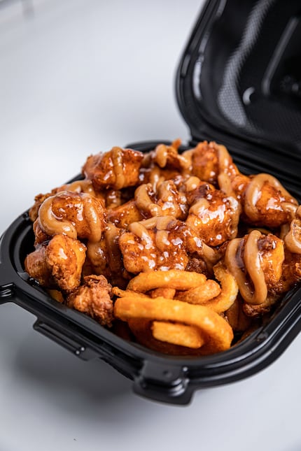 Bad Chicken's nuggets come in "chicken bomb bowls," served on a bed of curly fries. Pictured...
