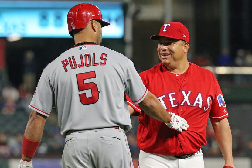 Los Angeles Angels designated hitter Albert Pujols (5) checks with Texas Rangers pitcher...