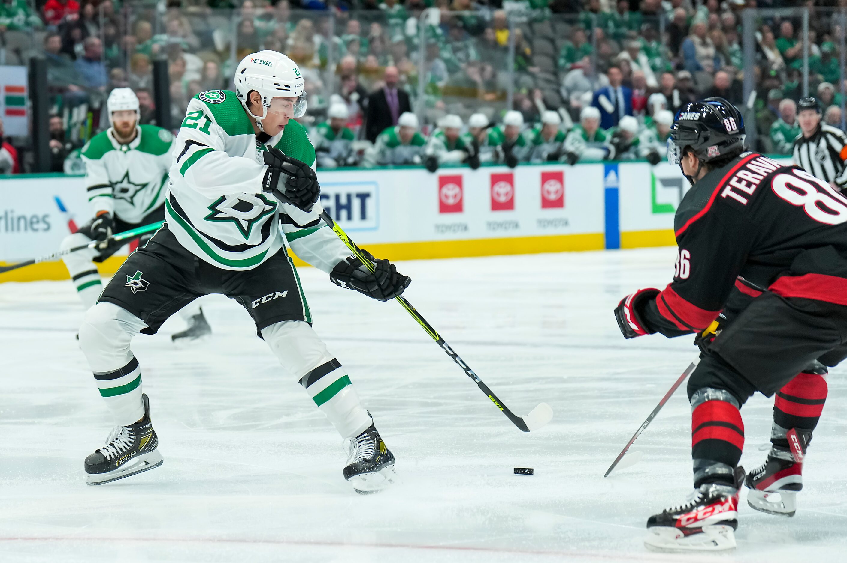 Dallas Stars left wing Jason Robertson (21) controls the puck against Carolina Hurricanes...