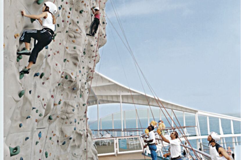 Passengers tackle the rock-climbing wall on Royal Caribbean's Navigator of the Seas.