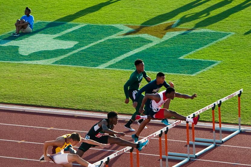 Runners compete in the boys 110m hurdles during the UIL Class 5A state track finals on Sat.,...