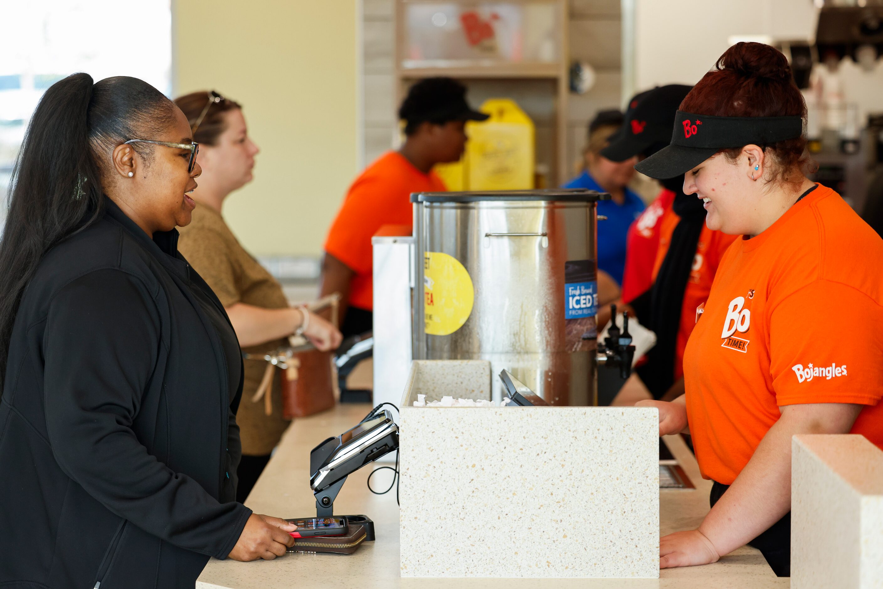 Samira Pervis (left) of North Carolina, talks to employee Dakota Prinz as Pervis orders her...