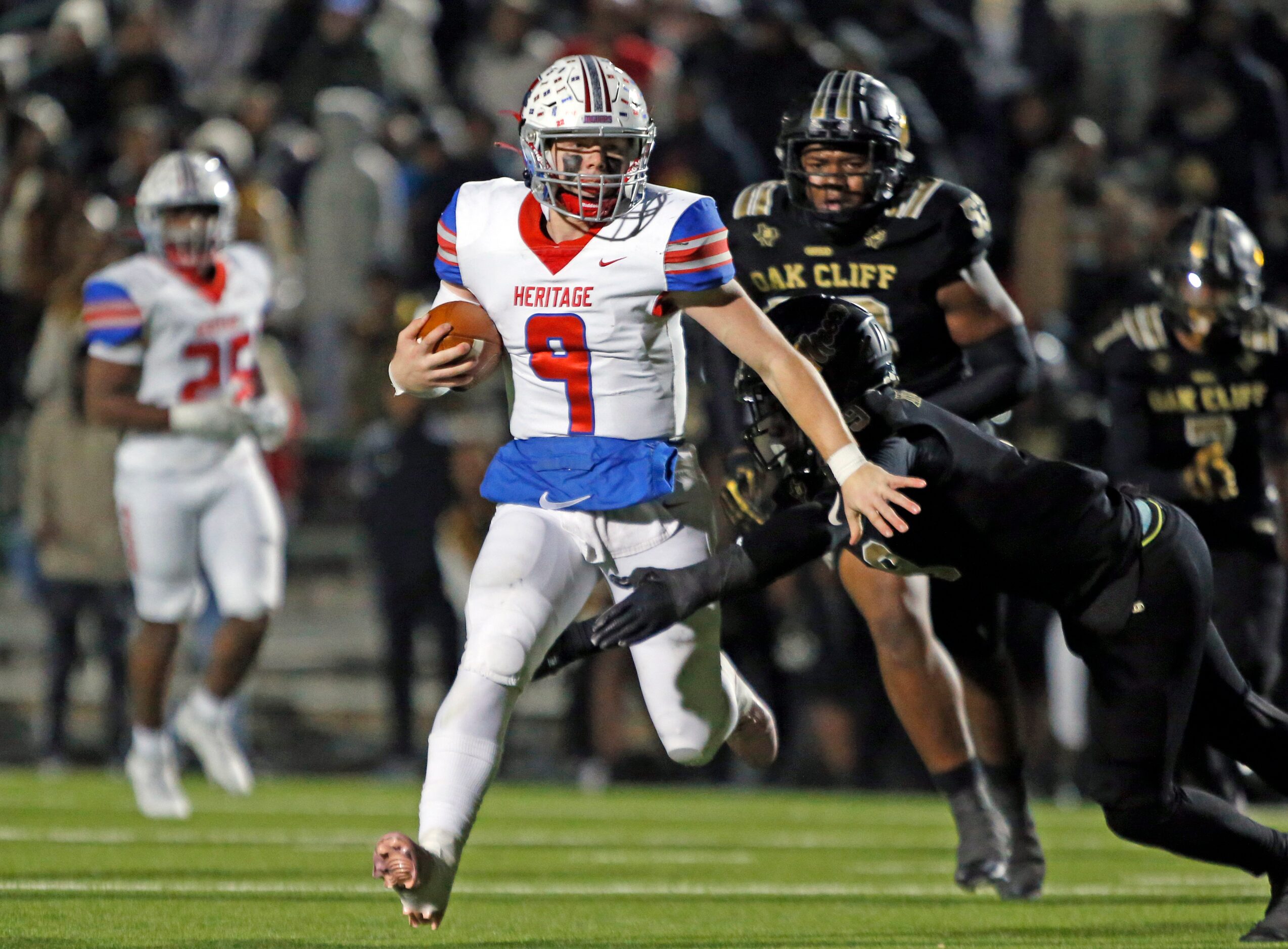 Midlothian Heritage high QB Carter Rutenbar (9) scrambles for a first down during the first...