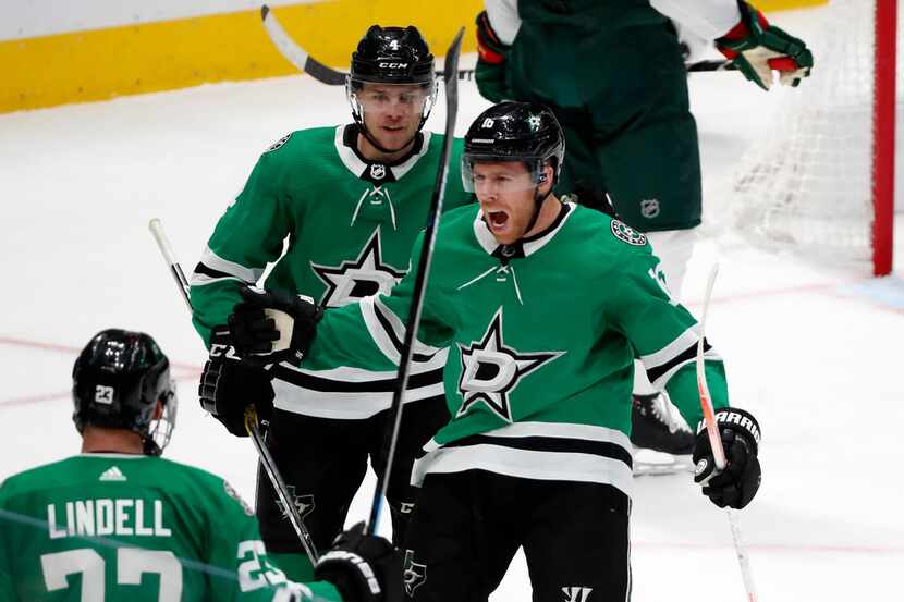 Dallas Stars defenseman Esa Lindell (23), Joe Pavelski (16) and Miro Heiskanen (4) celebrate...