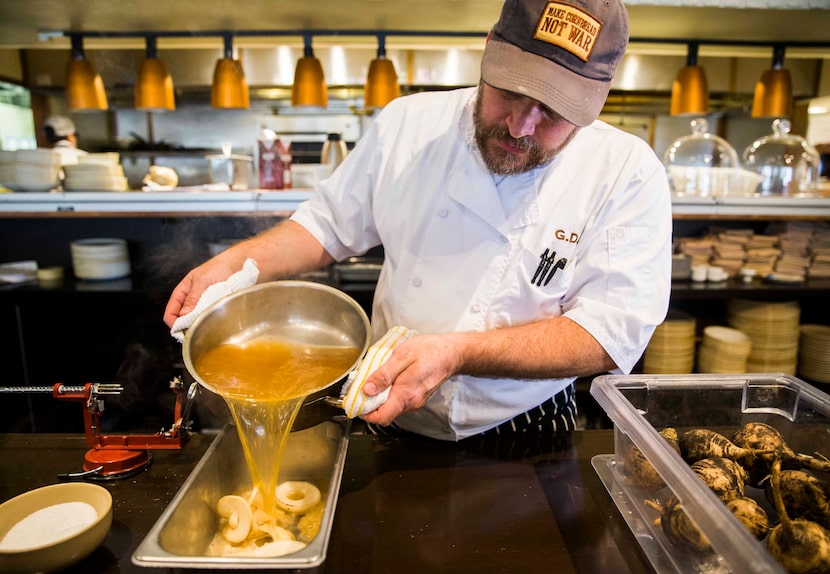 Chef Graham Dodds pours pickling liquid over spiraled radishes on Thursday, March 31, 2016...