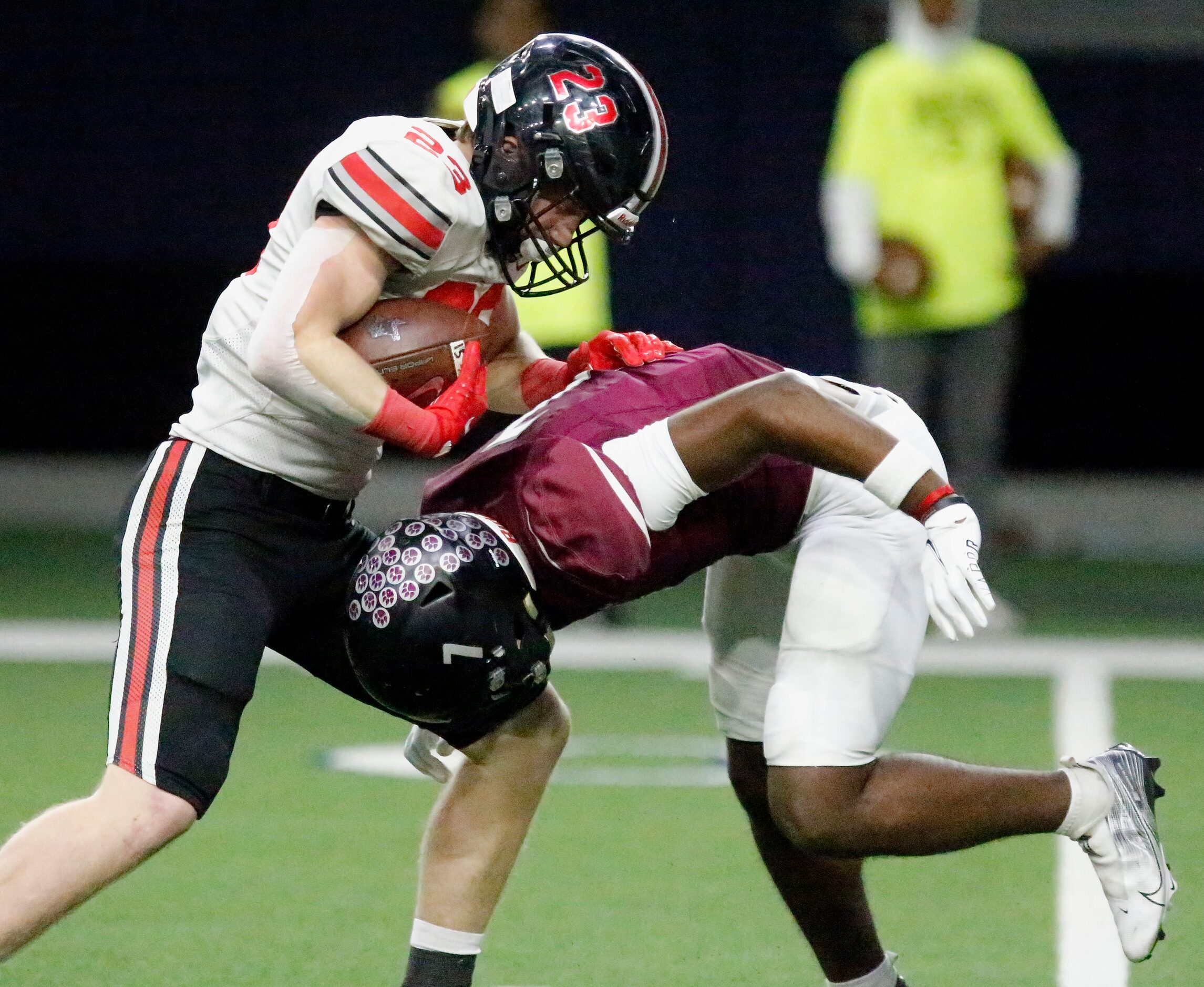 Lovejoy High School running back Dillon Magee (23) is hit in the backfield by Mansfield...