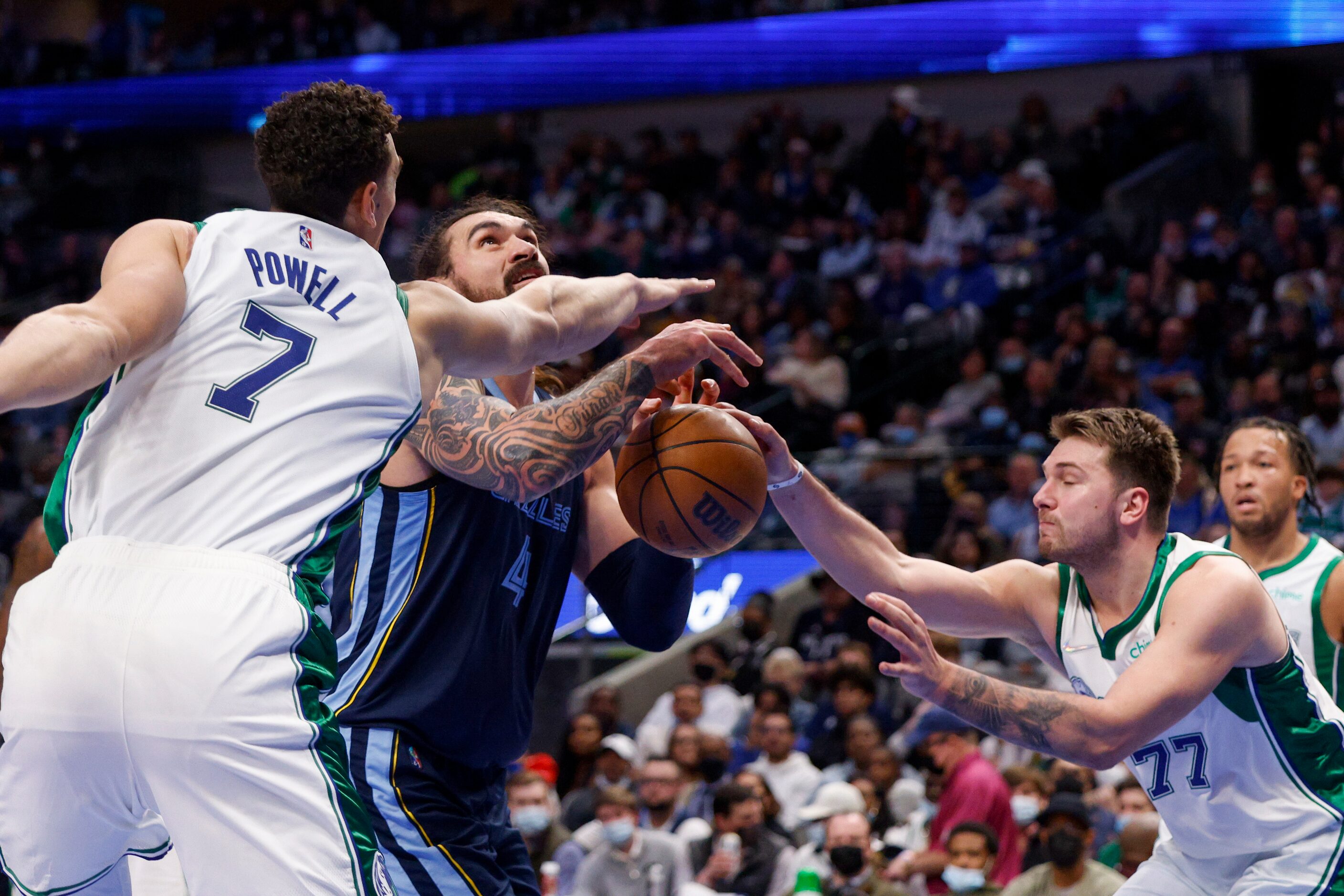 Dallas Mavericks center Dwight Powell (7) and guard Luka Doncic (77) knock the ball loose...