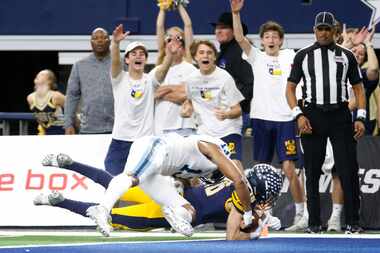 Highland Park's Finn Corwin (16) dives into the end zone for a touchdown as Shadow Creek's...