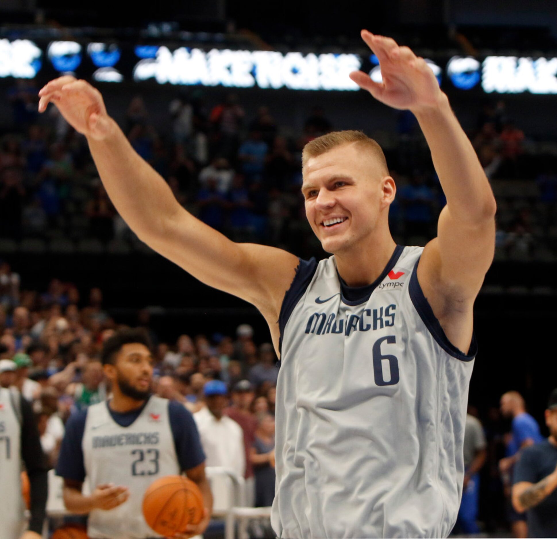 Dallas Mavericks center Kristaps Porzingis (6) enters the court and responds to fans...