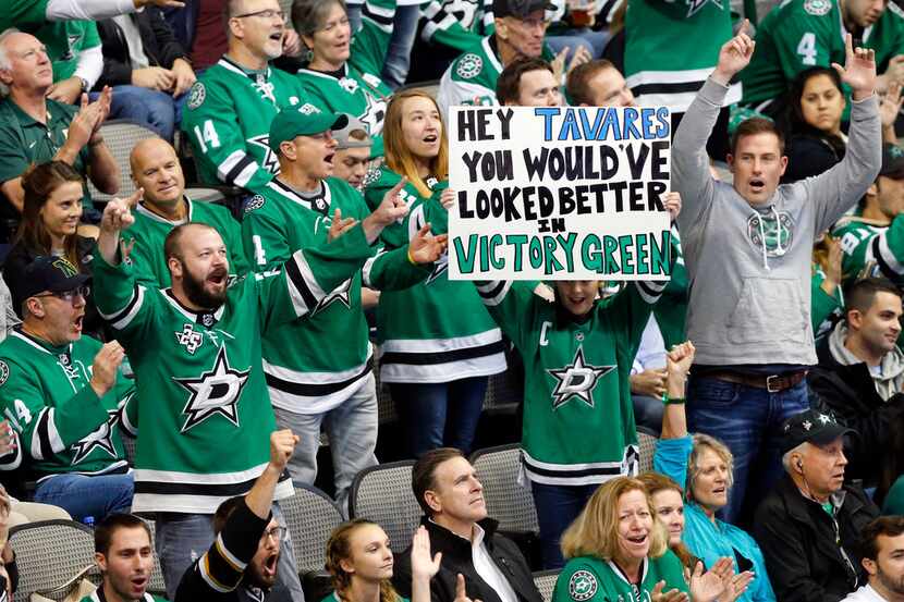 Dallas Stars fans cheer after a review of a Stars goal was good during the third period...