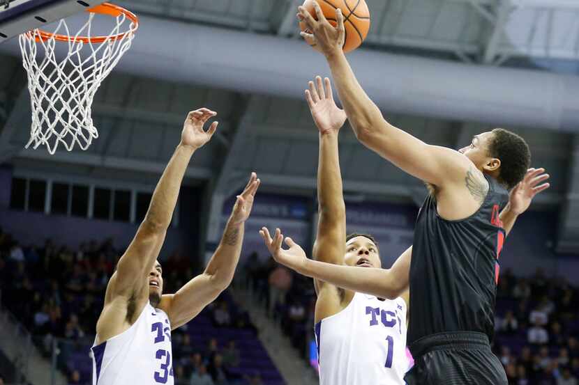 Southern Methodist Mustangs forward Ethan Chargois (5) attempts a shot in front of TCU...