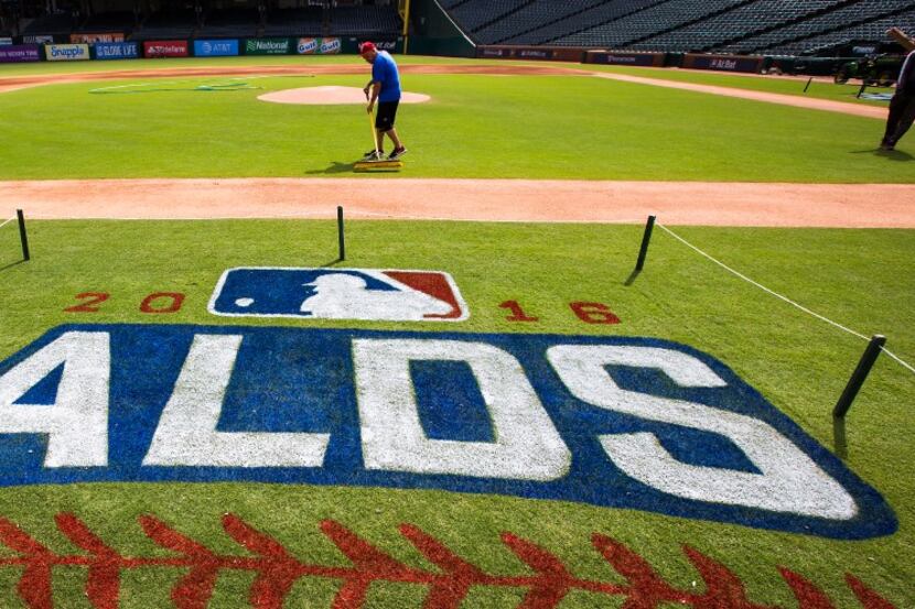 Groundskeepers prepare the field before the Texas Rangers workout at Globe Life Park in...