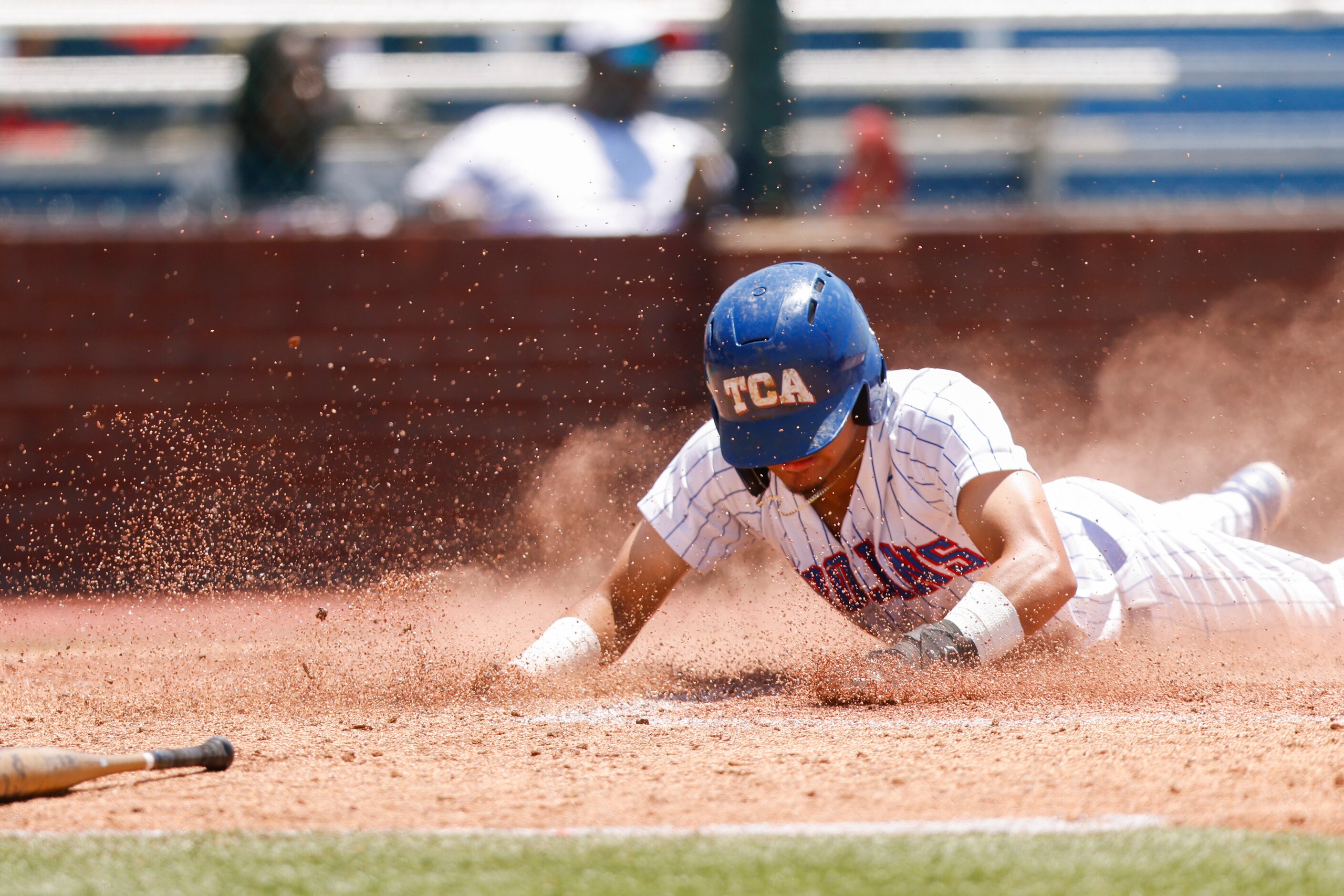 Trinity Christian’s Steven Ramos (12) slides into home in the third inning against Houston...