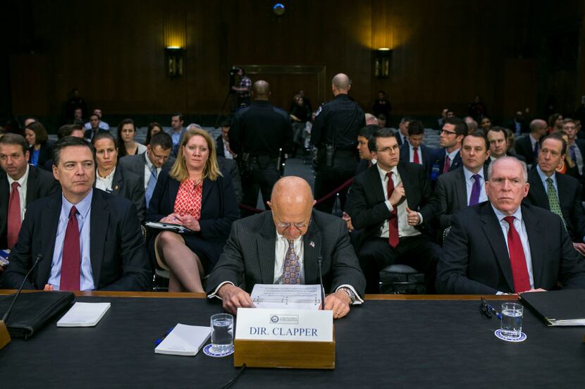 From left: FBI Director James Comey, National Intelligence Director James Clapper and CIA...