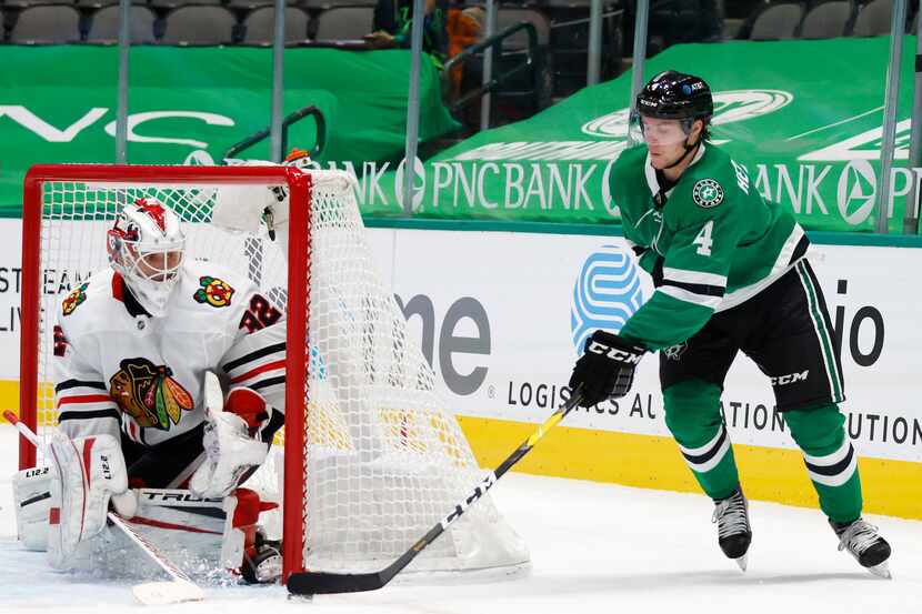 Dallas Stars defenseman Miro Heiskanen (4) attempts a shot on goal as Chicago Blackhawks...