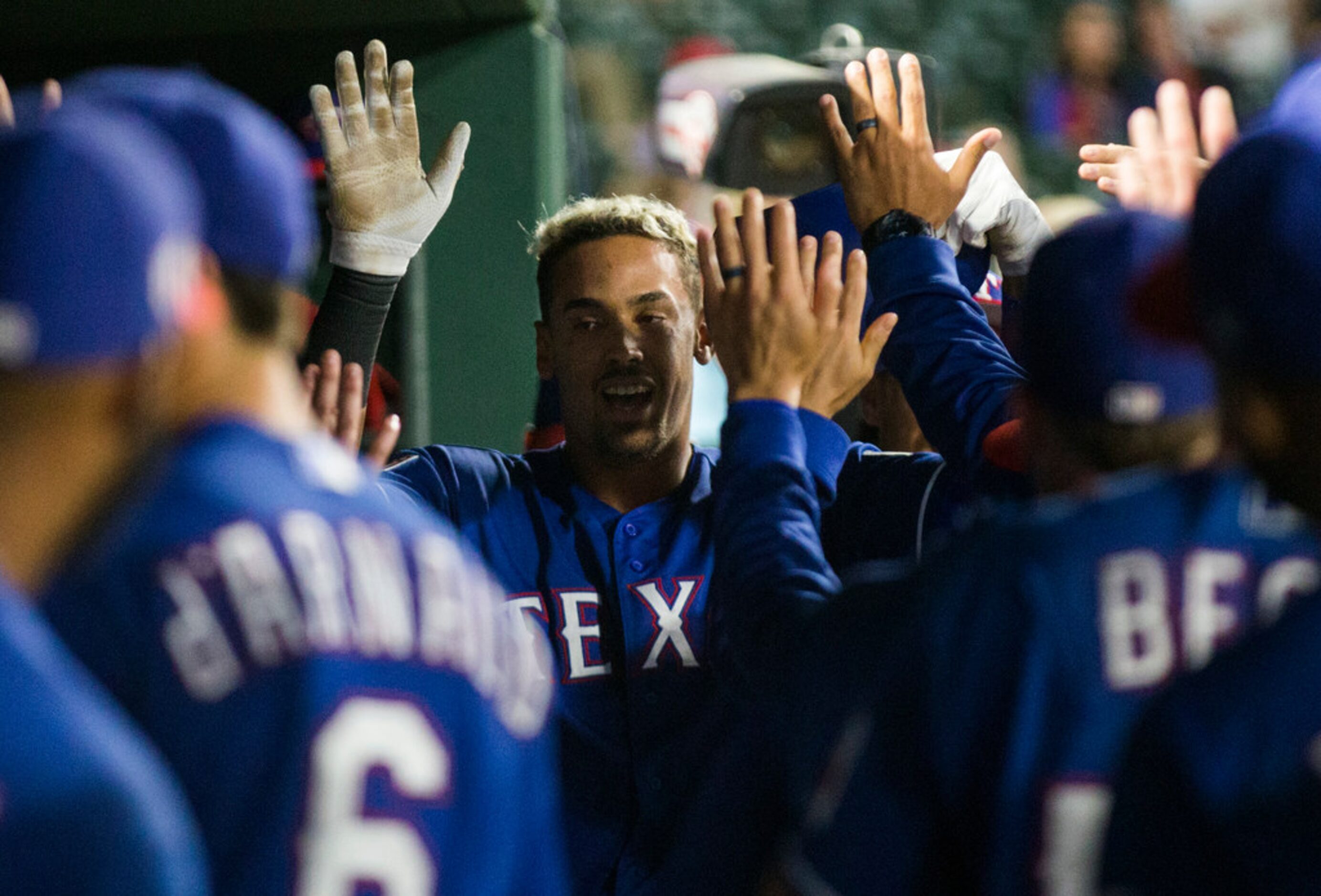 Texas Rangers first baseman Ronald Guzman (11) celebrates after a home run during the fifth...