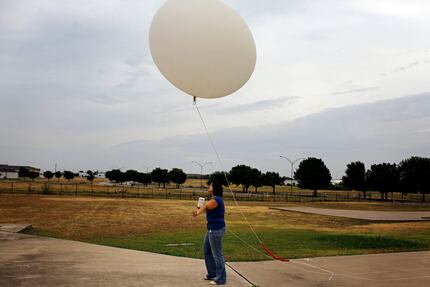 Amber Elliott, a meteorologist with the National Weather Service, released a weather balloon...