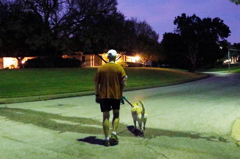 Dr. Alan Johns walks his dog, Zoe, on one of their thrice-weekly predawn walks. The Fort...
