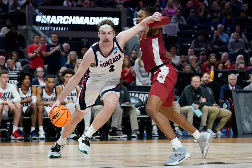 FILE - Gonzaga forward Drew Timme, left, drives to the basket against Arkansas guard Stanley...