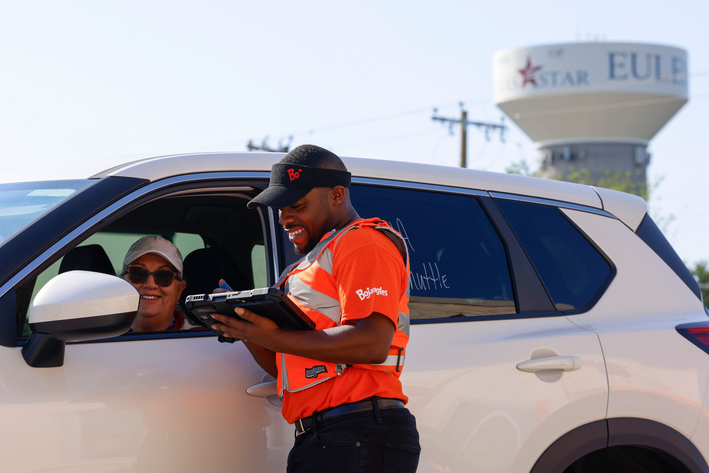 Judy Harris of Euless (left) smiles as she orders her meal with Lamont George during the...