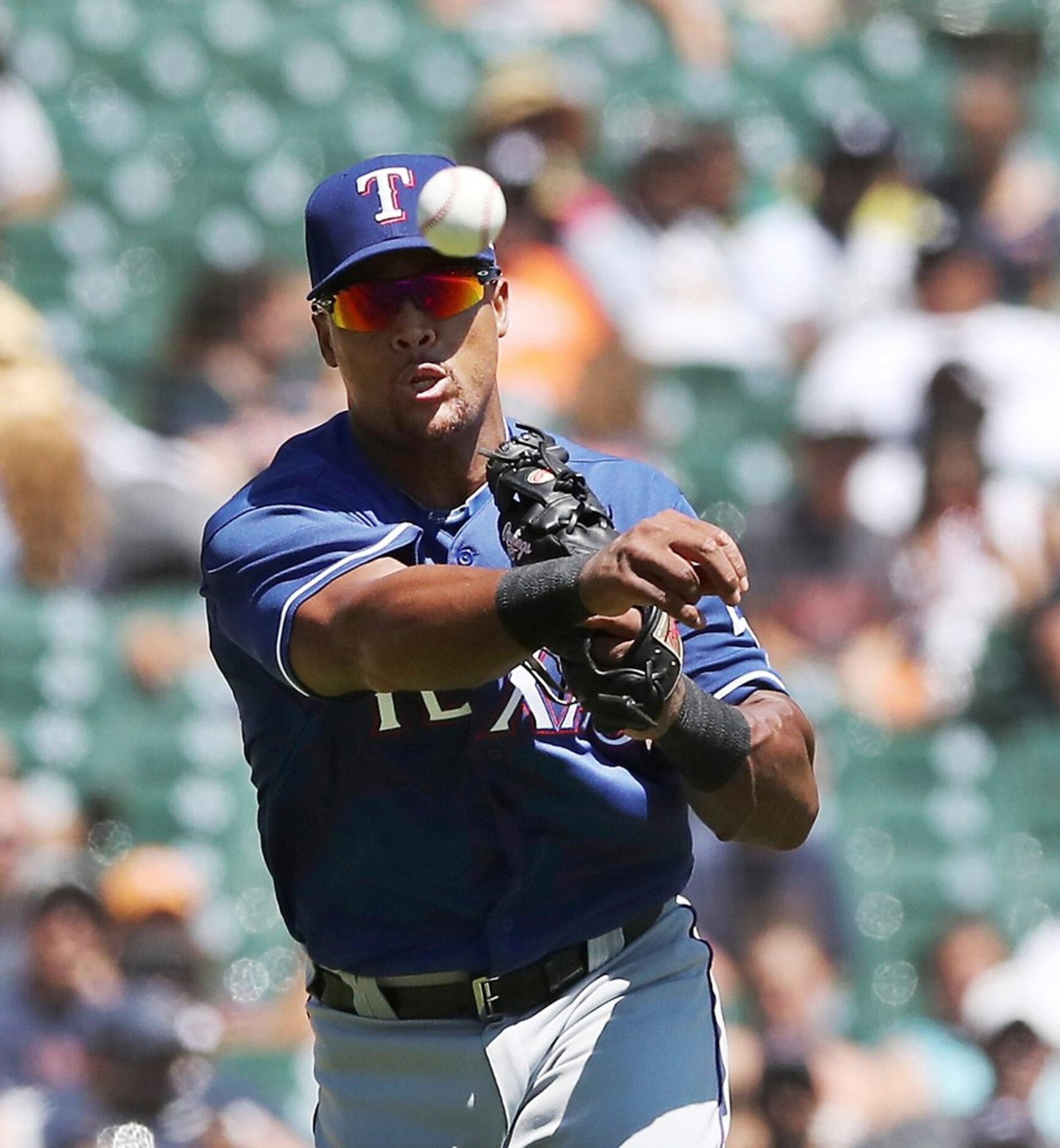 Texas Rangers third baseman Adrian Beltre throws to first for the out on Detroit Tigers'...